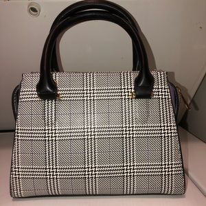 Cute purse with purple detail.